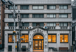 日本銀行の建物と金利グラフ、円のシンボルが描かれたイラスト。